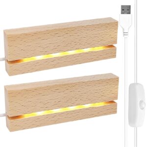 Två träbaser med varmvita LED-ljus och USB-kablar med strömbrytare.
