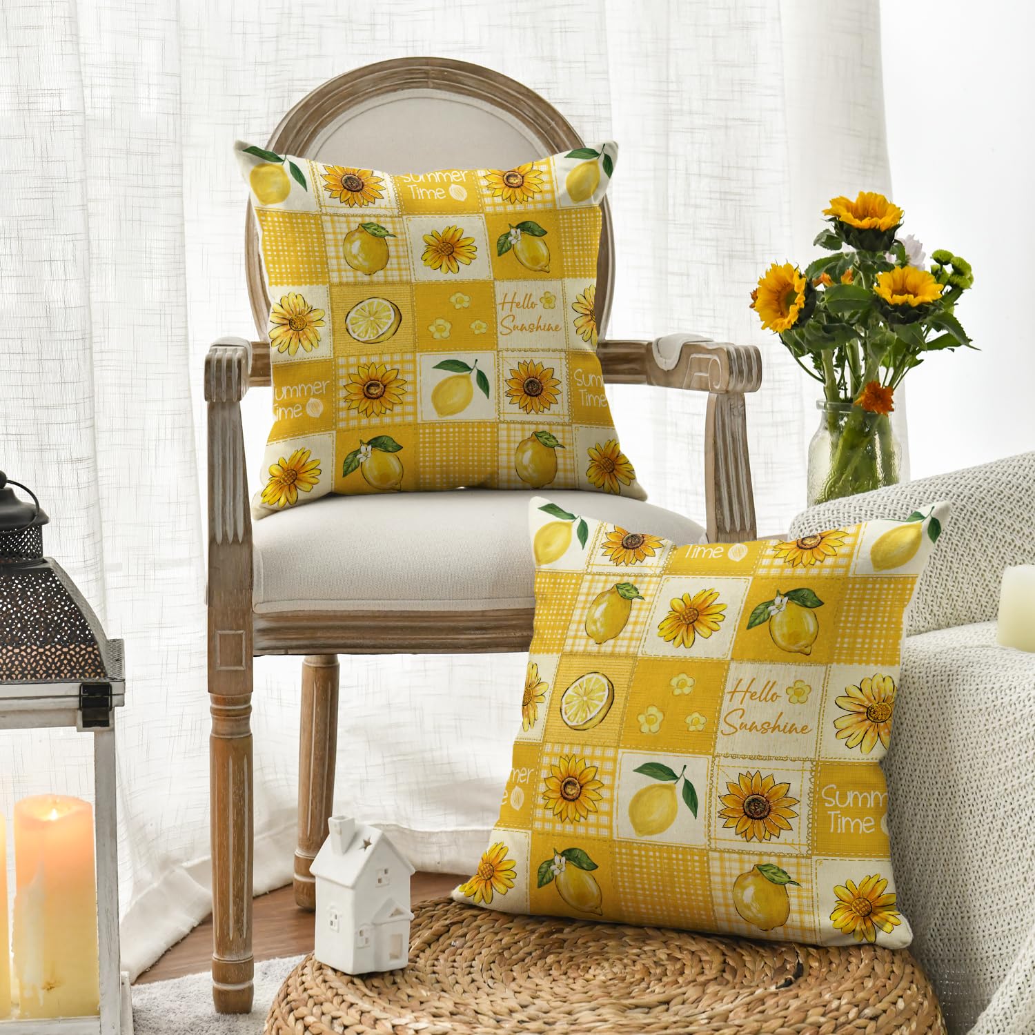 Två gula kuddfodral med citron- och solrosmönster, arrangerade på en stol och en pall.